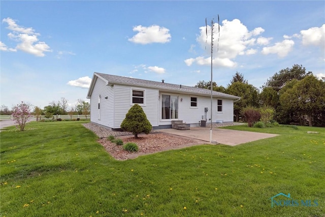 back of property featuring a patio area, a yard, and entry steps