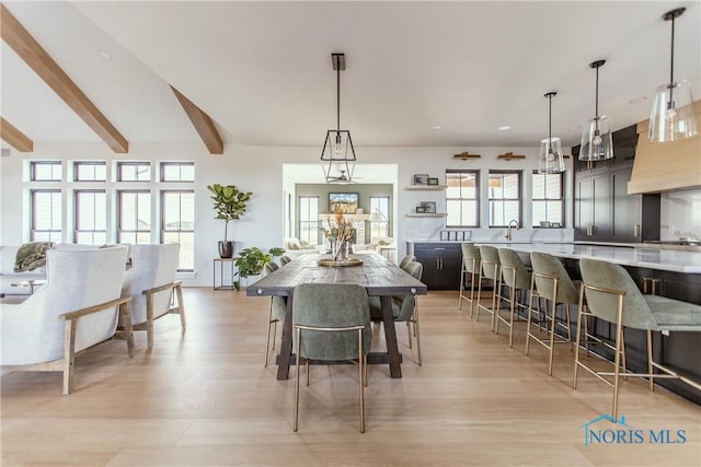 dining room featuring beam ceiling, recessed lighting, and light wood finished floors