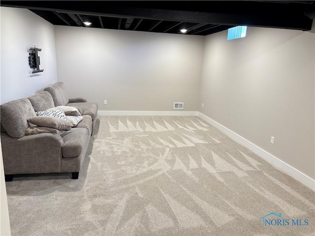 unfurnished room featuring baseboards, visible vents, and carpet