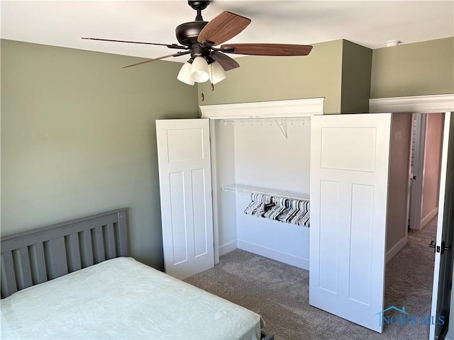 carpeted bedroom with baseboards and a ceiling fan