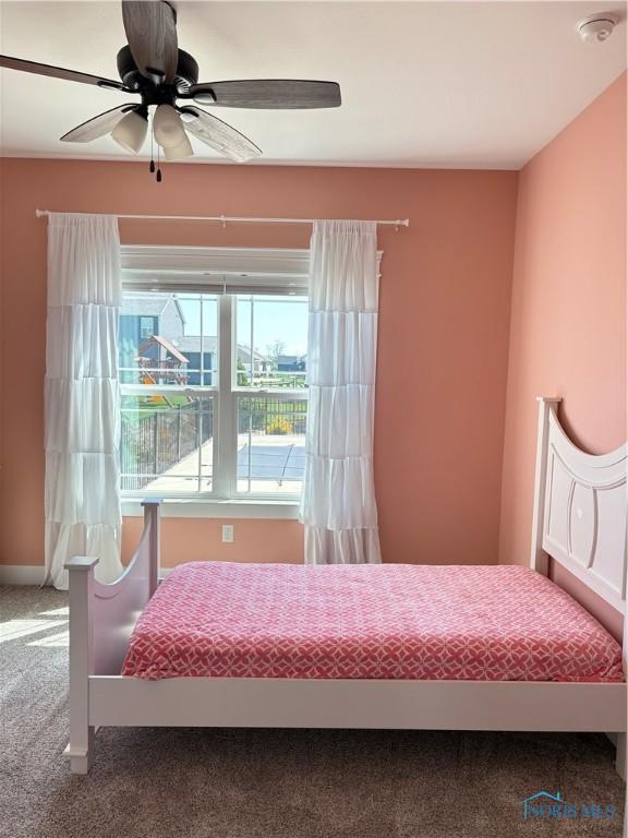 bedroom featuring a ceiling fan and carpet