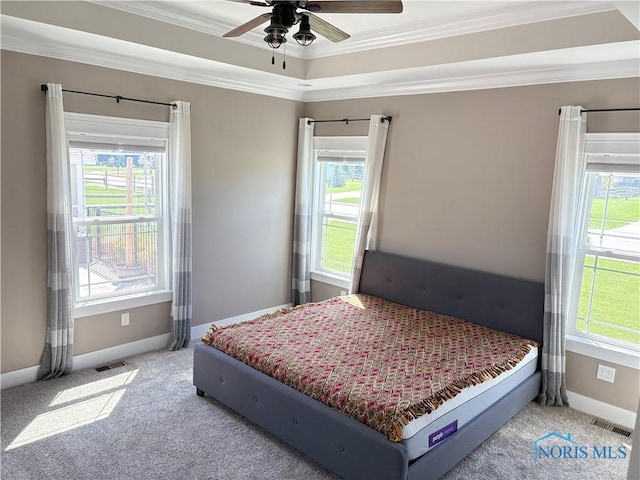 bedroom with crown molding, visible vents, carpet floors, and baseboards