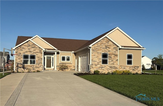 craftsman-style home with a garage, a front yard, driveway, and stone siding