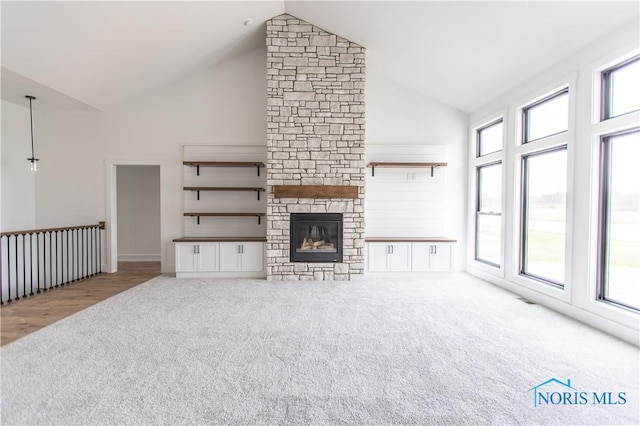 unfurnished living room with high vaulted ceiling, baseboards, carpet floors, and a fireplace