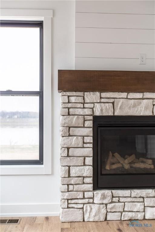 interior details with visible vents, wood finished floors, and baseboards