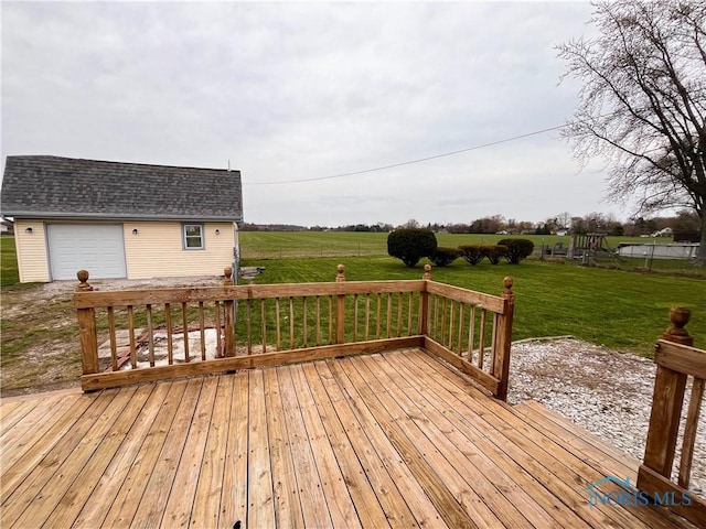 wooden terrace featuring an outdoor structure and a yard