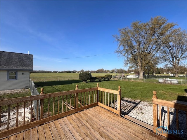 wooden deck with a lawn and a rural view