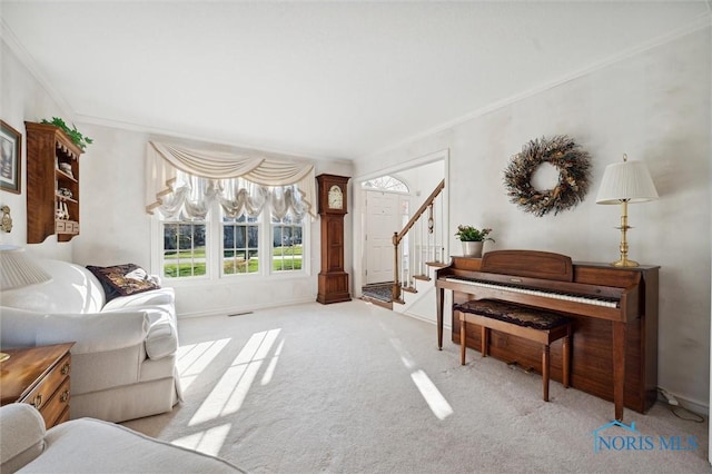 living area with carpet, crown molding, baseboards, and stairs