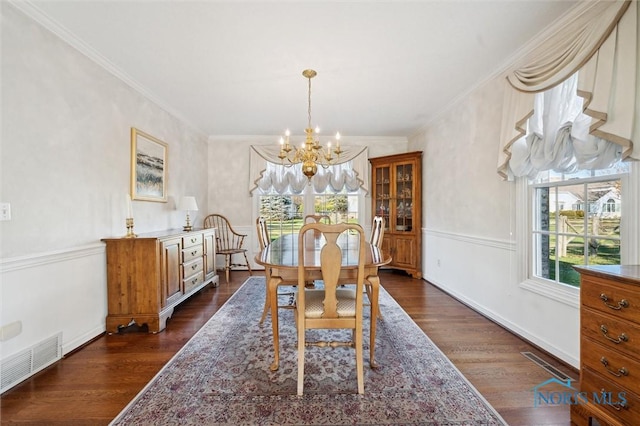 dining space with a chandelier, crown molding, visible vents, and dark wood finished floors