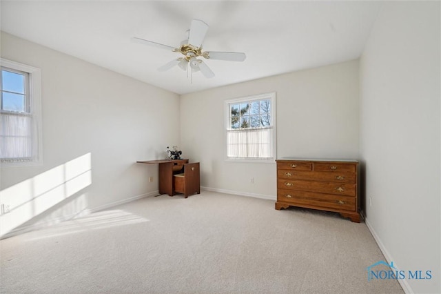 carpeted bedroom featuring baseboards and a ceiling fan