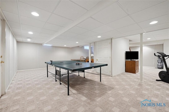playroom featuring a paneled ceiling and carpet floors