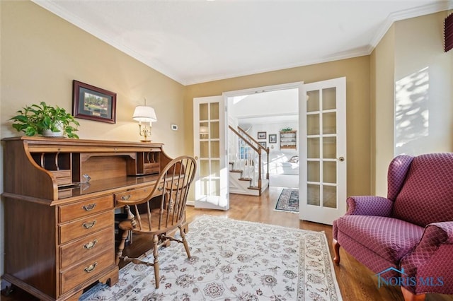 home office featuring wood finished floors, french doors, and crown molding