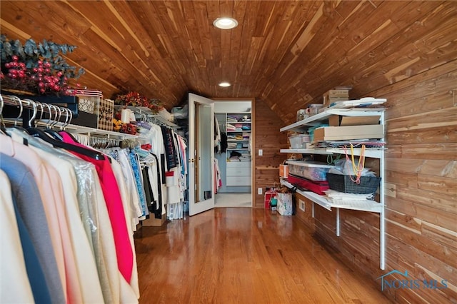spacious closet with wood finished floors and vaulted ceiling