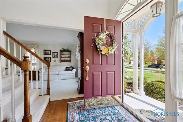 foyer entrance featuring wood finished floors and stairs