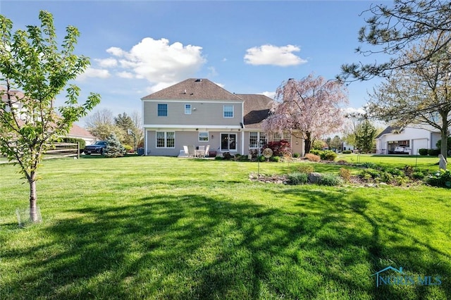 back of property with a yard