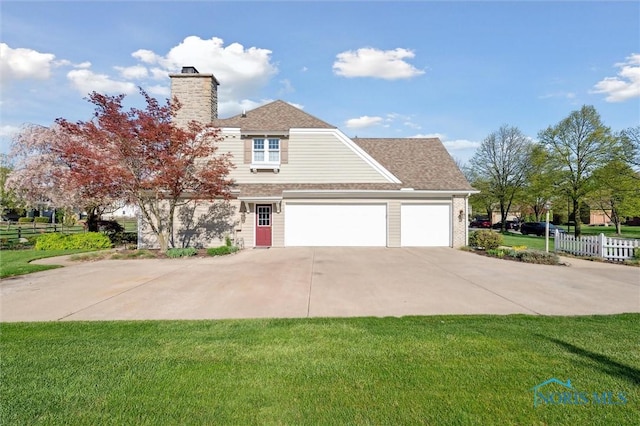 traditional-style home with concrete driveway, a chimney, fence, a front lawn, and a garage