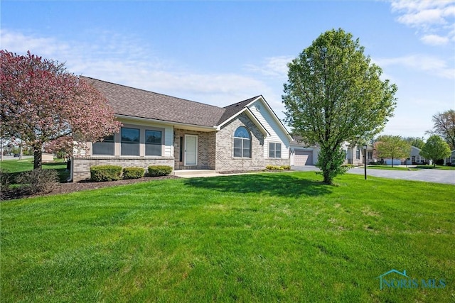 8 Zachary Cir, Waterville, OH 43566 - ranch-style house with brick siding, a front lawn, and roof with shingles
