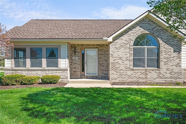 8 Zachary Cir, Waterville, OH 43566 - ranch-style home with brick siding, a shingled roof, and a front yard