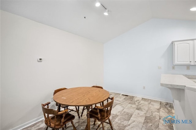 8 Zachary Cir, Waterville, OH 43566 - dining space featuring baseboards, rail lighting, and vaulted ceiling
