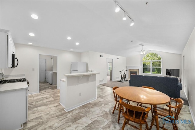 8 Zachary Cir, Waterville, OH 43566 - dining room with a ceiling fan, visible vents, baseboards, lofted ceiling, and a glass covered fireplace
