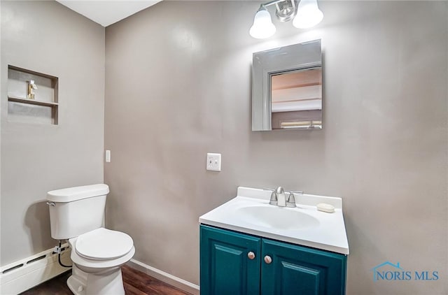3533 Edgevale Rd, Ottawa Hills, OH 43606 - bathroom featuring vanity, toilet, baseboards, wood finished floors, and a baseboard radiator