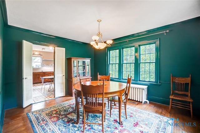3533 Edgevale Rd, Ottawa Hills, OH 43606 - dining room featuring radiator, wood finished floors, and a chandelier