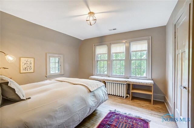 3533 Edgevale Rd, Ottawa Hills, OH 43606 - bedroom with visible vents, radiator heating unit, wood finished floors, and baseboards