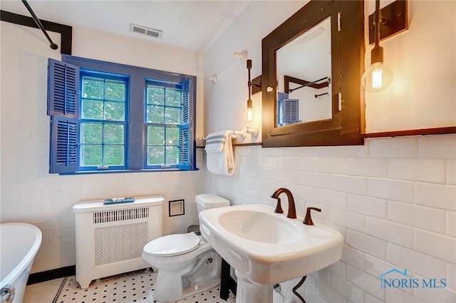 3533 Edgevale Rd, Ottawa Hills, OH 43606 - full bathroom with walk in shower, a freestanding bath, tile walls, radiator, and visible vents