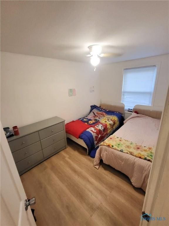 bedroom featuring a ceiling fan and wood finished floors