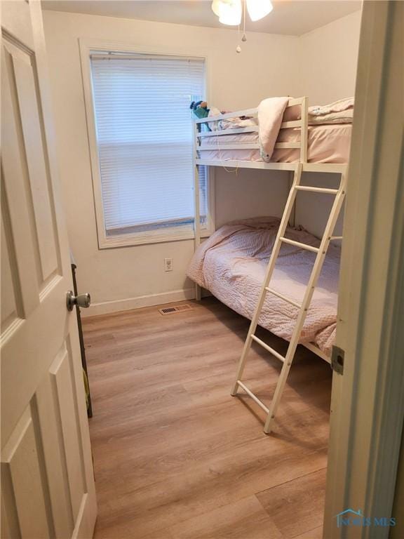 bedroom featuring visible vents, baseboards, and light wood-type flooring