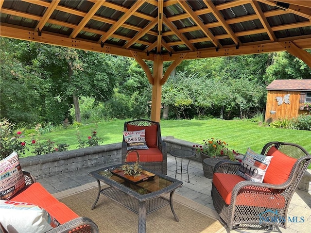 view of patio / terrace featuring a gazebo, an outbuilding, and a storage shed
