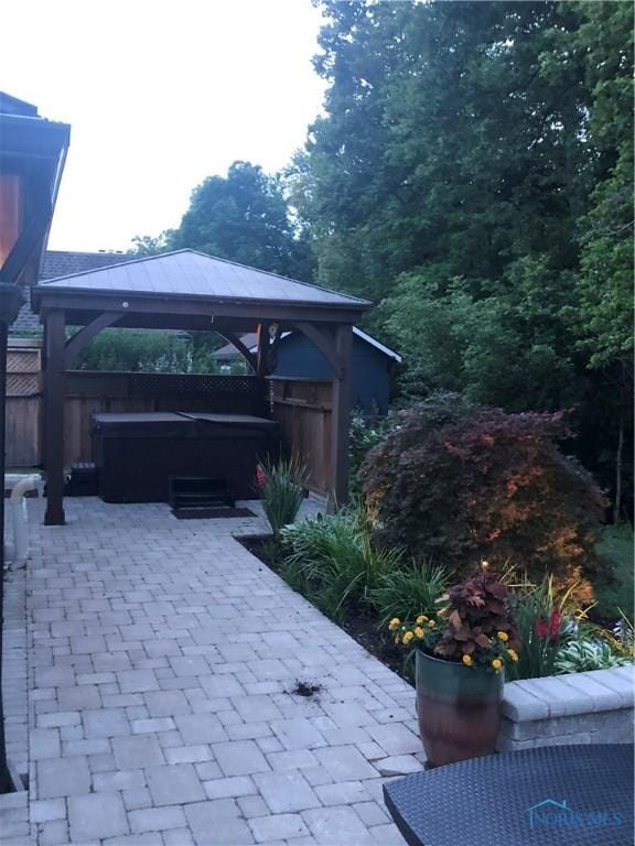 view of patio / terrace with a gazebo and a hot tub