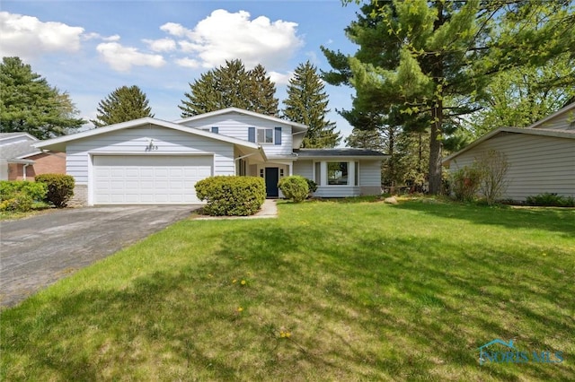 view of front of home featuring a garage, driveway, and a front lawn