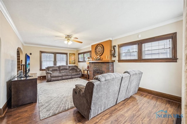 1805 Heatherdowns Blvd, Toledo, OH 43614 - living room featuring a ceiling fan, baseboards, a fireplace, arched walkways, and wood finished floors