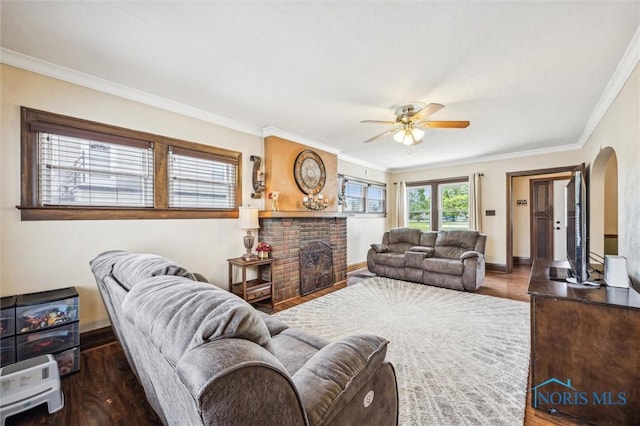1805 Heatherdowns Blvd, Toledo, OH 43614 - living room featuring a fireplace, wood finished floors, ceiling fan, arched walkways, and crown molding