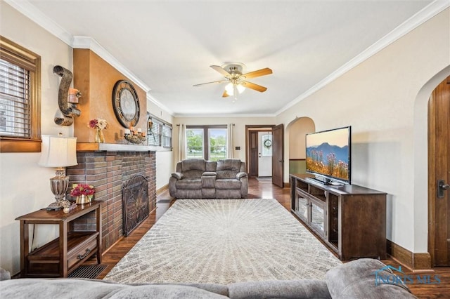 1805 Heatherdowns Blvd, Toledo, OH 43614 - living area featuring arched walkways, ceiling fan, a fireplace, baseboards, and wood finished floors