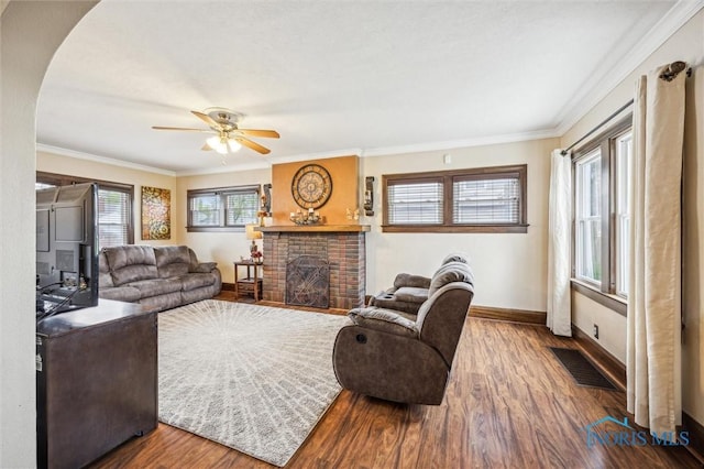 1805 Heatherdowns Blvd, Toledo, OH 43614 - living room featuring wood finished floors, baseboards, ceiling fan, ornamental molding, and a brick fireplace