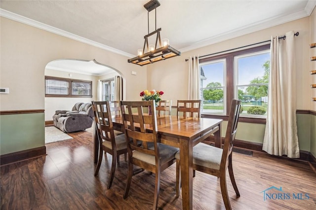 1805 Heatherdowns Blvd, Toledo, OH 43614 - dining space with arched walkways, baseboards, wood finished floors, crown molding, and a chandelier
