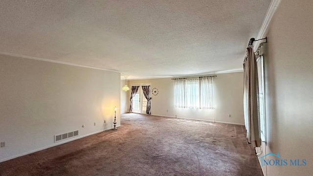 carpeted empty room featuring ornamental molding, a textured ceiling, visible vents, and baseboards