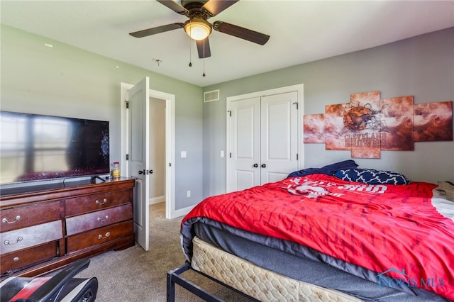 bedroom with visible vents, a closet, baseboards, ceiling fan, and carpet