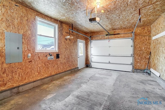garage with a garage door opener and electric panel