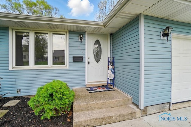 property entrance featuring an attached garage