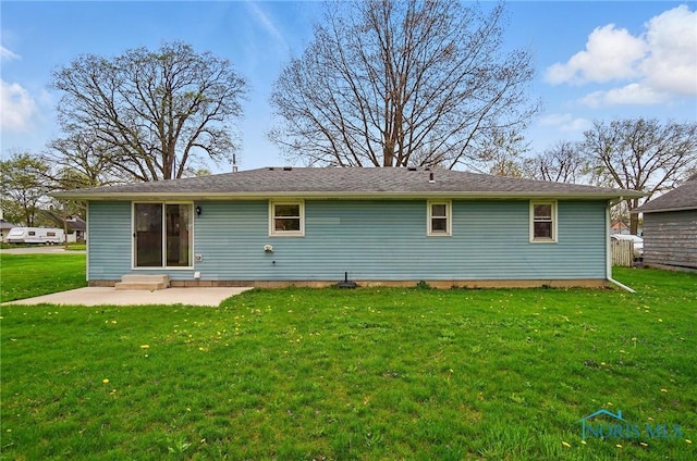 rear view of house featuring a patio, a yard, and entry steps