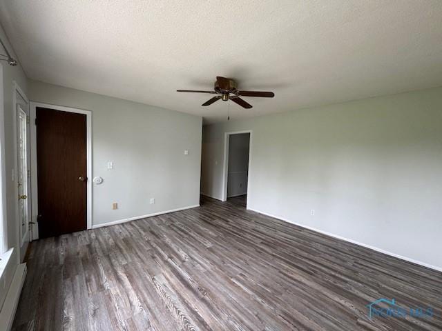 empty room featuring wood finished floors, ceiling fan, and baseboards