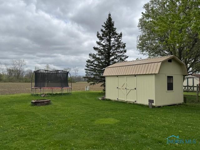 view of shed with a trampoline