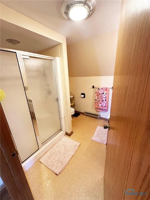 399 Melmore St, Tiffin, OH 44883 - full bath featuring toilet, a stall shower, baseboard heating, and lofted ceiling