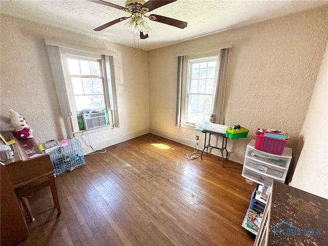 399 Melmore St, Tiffin, OH 44883 - interior space with a ceiling fan, a textured wall, a wealth of natural light, and wood finished floors