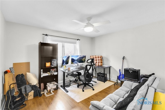 home office featuring wood finished floors and ceiling fan
