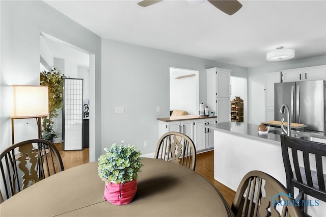 dining space featuring dark wood finished floors and a ceiling fan