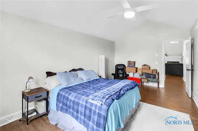 bedroom featuring lofted ceiling, wood finished floors, and visible vents